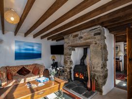 A living room with a fireplace and sofa at Trehaverock Cottage in St. Endellion near Port Isaac