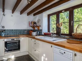 A kitchen with wooden surfaces and appliances at Trehaverock Cottage in St. Endellion near Port Isaac