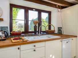 A kitchen with a sink and windows at Trehaverock Cottage St. Endellion near Port Isaac