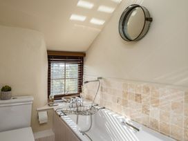A bathroom with a bathtub and toilet at Trehaverock Cottage in St. Endellion near Port Isaac