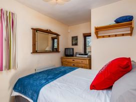 A bedroom with a bed and dresser at Trehaverock Cottage St. Endellion near Port Isaac