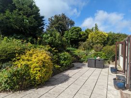 A garden with flower beds and outdoor furniture at Trehaverock Cottage St. Endellion near Port Isaac
