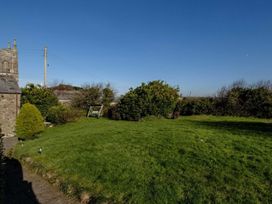 A garden with grass and bushes at Trehaverock Cottage in St. Endellion near Port Isaac