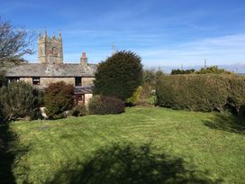 A garden with grass and trees at Trehaverock Cottage in St. Endellion near Port Isaac