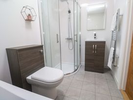 A bathroom with a shower and toilet at Agan Paradhis in Quintrell Downs