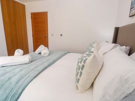 A bedroom with a bed and towels neatly arranged at Agan Paradhis in Quintrell Downs