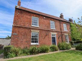 A brick house with garden at Reighton House in Filey