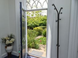 An entrance with a door open to a garden at Reighton House in Filey
