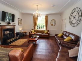 A living room with a sofa and a coffee table at Reighton House in Filey