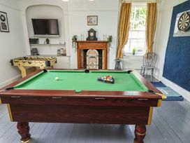 A game room with a pool table and TV at Reighton House in Filey