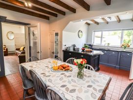 A kitchen with a dining table and orange juice at Reighton House in Filey