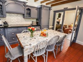 A kitchen with a table and chairs at Reighton House in Filey