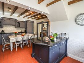 A kitchen with a table and chairs at Reighton House in Filey