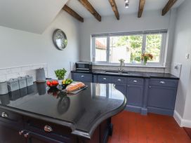 A kitchen with a sink and kitchen island at Reighton House in Filey