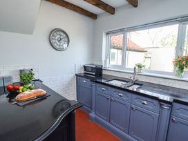 A kitchen with a sink and countertop at Reighton House in Filey