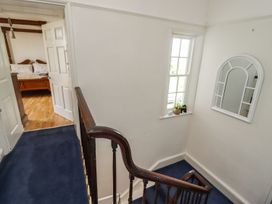A hallway with a staircase and a window at Reighton House in Filey
