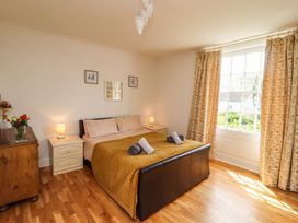 A bedroom with a bed and nightstand at Reighton House in Filey