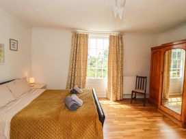 A bedroom with a bed and wardrobe at Reighton House in Filey