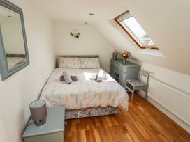 A bedroom with a bed and dresser at Reighton House in Filey