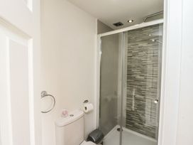 A bathroom with a shower and toilet at Reighton House Filey