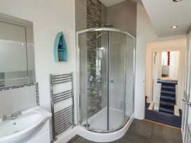 A bathroom with a shower and basin at Reighton House in Filey