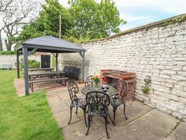 A garden area with a gazebo, table, and chairs at Reighton House in Filey