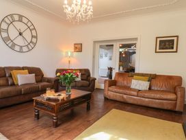 A living room with sofas and a coffee table at Reighton House Reighton near Filey