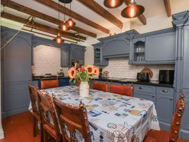 A kitchen with a table and chairs at Reighton House in Reighton near Filey