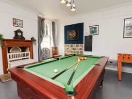 A game room with a pool table and foosball table at Reighton House in Reighton near Filey