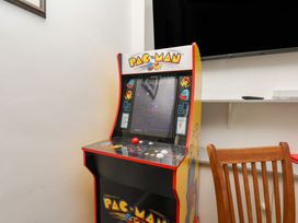 An arcade machine with a Pac-Man theme in a game room at Reighton House in Reighton near Filey
