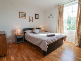 A bedroom with a bed and nightstand at Reighton House in Reighton near Filey