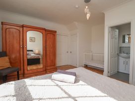 A bedroom with a bed and wardrobe at Reighton House in Reighton near Filey