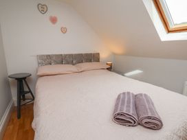 A bedroom with a bed and a bedside table at Reighton House in Reighton near Filey