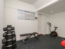 A gym with dumbbells and an exercise bike at Reighton House in Reighton near Filey