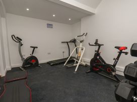 A gym with exercise equipment and mats at Reighton House in Reighton near Filey