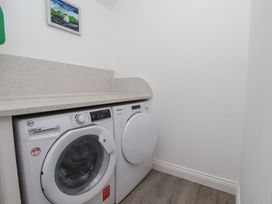 A laundry room with a washing machine and tumble dryer at Reighton House in Reighton near Filey