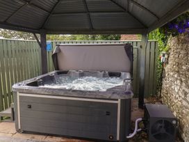 A hot tub under a canopy in an outdoor area at Reighton House near Filey