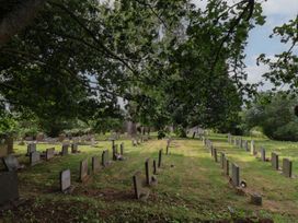 A cemetery with headstones and grass at Reighton House in Reighton near Filey
