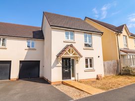 A house with a driveway and garden at 24 Higher Gorse Road in Roughton