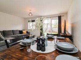A living room with a dining table and sofa at 24 Higher Gorse Road in Roughton