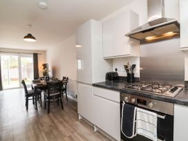 A kitchen with an island and dining area at 24 Higher Gorse Road in Roughton