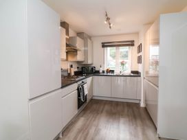 A kitchen with appliances and a window at 24 Higher Gorse Road in Roughton
