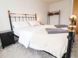 A bedroom with a bed and nightstand at 24 Higher Gorse Road Roughton