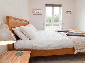 A bedroom with a bed and window at 24 Higher Gorse Road Roughton