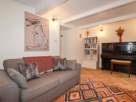 A living room with a sofa and piano at Seveock in Threemilestone