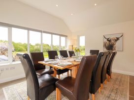 A dining room with a wooden table and chairs at Seveock in Threemilestone