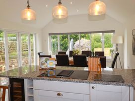 A kitchen with an island and dining table at Seveock in Threemilestone