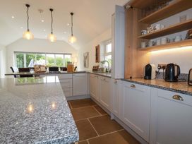A kitchen with cabinets and an island at Seveock in Threemilestone