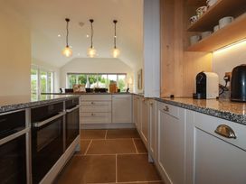 A kitchen with cabinets and appliances at Seveock in Threemilestone
