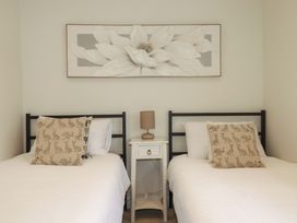 A bedroom with two beds and a nightstand at Seveock in Threemilestone